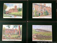Four place mats showing Furness Abbey, Hawes End Village, The Hall Amesbury Park, Ribblehead Viaduct with dark green borders and gold accents.