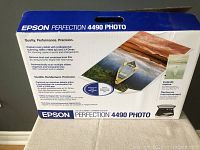 Original retail box of the Epson Perfection 4490 Photo scanner showing product branding and features.