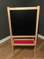 Front view displaying black chalkboard surface and red tray paper roll holder under it.
