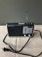 Full-view of Emerson radio with extended antenna and power cord visible.