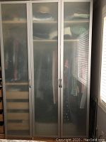 Six tall closet doors with frosted glass panels and metal frames, three shown in photo, doors closed inside a room closet.
