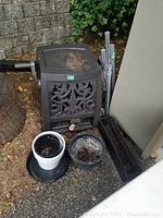 Wide view showing garden hose reel, planter pots, metal poles, and rectangular planter box