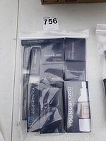 View of entire sealed set with multiple Youngblood cosmetic products in branded packaging.