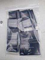 Photo of the full lot of new Youngblood mineral cosmetics sealed in plastic bag showing black boxes with white logo.