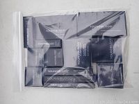 Complete lot of Youngblood mineral cosmetics in sealed boxes inside clear plastic bag.