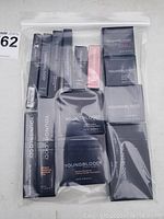 Full view of all Youngblood mineral cosmetics items in clear plastic zip bag, showing various boxed makeup products.