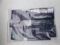 Plastic bag containing multiple boxed Youngblood mineral makeup products.