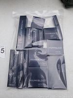Full lot of unopened Youngblood Mineral Cosmetics in black packaging inside a clear plastic zip bag.