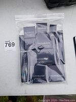 Youngblood mineral cosmetics in original black packaging sealed in a plastic bag, showing the variety of products including blush, concealer, foundation, and lipstick.