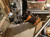 Wilson left-handed golf clubs in PowerBuilt golf bag with multiple compartments, standing on floor.