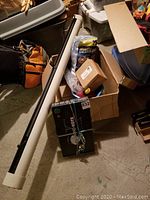 Overview of car care pack box, microfiber towels, packed in cardboard boxes along with a white tube containing a retractable mesh sunshade and an orange gas can.