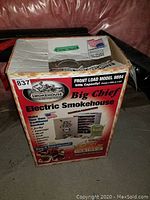 Box of Big Chief Electric Smokehouse Model 9894 showing front load, 50lb capacity label.