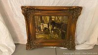 Full front view of framed oil painting of horses