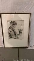 Framed full view of the etching showing elderly man holding flowers, dimensions visible from seller description