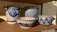 Four salt glaze stoneware items including two crocks and two bowls on wooden shelf