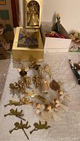 Wide-angle view of all Christmas angels and decorations laid out, including boxed wax head angel and multiple small angel ornaments.