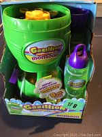 Front view of bubble machine in box with bottle and bubble solution