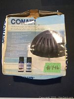 Box of Conair Aromatherapy Air Revitalizer showing product image, brand name, and included essential oils.