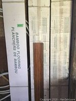 Boxes labeled bamboo flooring with packaging size and description