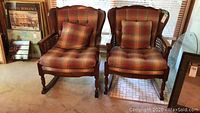 Both matching rocking chairs side by side with plaid cushions and cane sides visible.