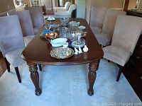 Overview of all six chairs around dining table with decorative items