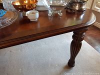 Close-up of carved reeded leg and apron showing finish and craftsmanship