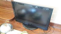 Full view of JVC 40 inch flat screen TV showing front with black frame and base stand.