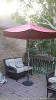 Overall view of loveseat and umbrella on deck