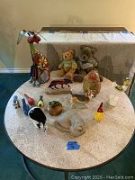 Full assortment of 15 animal figurines and plush teddy bears displayed on a round table.