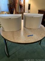 Pair of white B&W DS6 speakers displayed on table