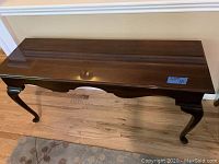 Front view showing full tabletop and carved legs of the wooden side table.