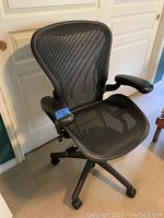 Full front view of the black mesh office chair
