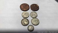Seven Canadian coins of various sizes and designs on white background
