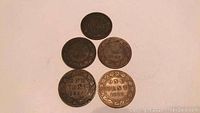Five Canada Large Penny coins arranged on a flat surface showing 'One Cent' and respective years.
