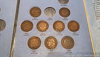 Overall set of Canadian Large Pennies from 1911 to 1920 in blue display case, with slot for each coin.