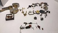 Collection of men's wristwatches, cufflinks, pins and tie bars arranged on table