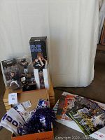 Full display of the lot showing the ring case, trophy box, bobbleheads, magazines, scarf, and MLB collectibles.