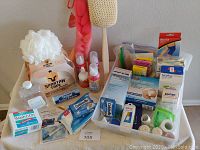 Full health care basket with assorted medical and first aid supplies placed in a white basket, showing items including bandages, spray bottles, and tape rolls.