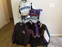 Full lot of Colorado Rockies baseball apparel including jackets, jerseys, and shirt arranged for display