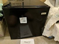 Front view of black Magic Chef mini fridge showing cube style design and brand label.