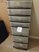 Front view of the 7 drawer mini chest showing the stacked translucent drawers in a black frame.