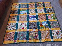Full view of the hand quilted Australian quilt laid flat on floor, showing multiple themed blocks with yellow and green borders.