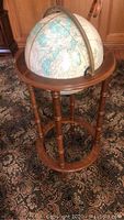 Full view of the Cram's Imperial World Globe mounted on the wooden stand.