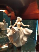 Front angled view showing entire figurine on glass shelf