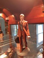 Front view of the doctor figurine showing facial detail, attire and base