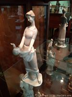 Three-quarter front view showing full figure and base