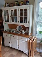Front view of two-piece white wood hutch and cabinet
