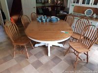 Group of six oak Windsor chairs around table