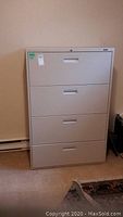 Full front view of four-drawer filing cabinet showing all drawers closed.