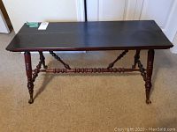 Full view of vintage wooden bench showing turned legs and dark stained top